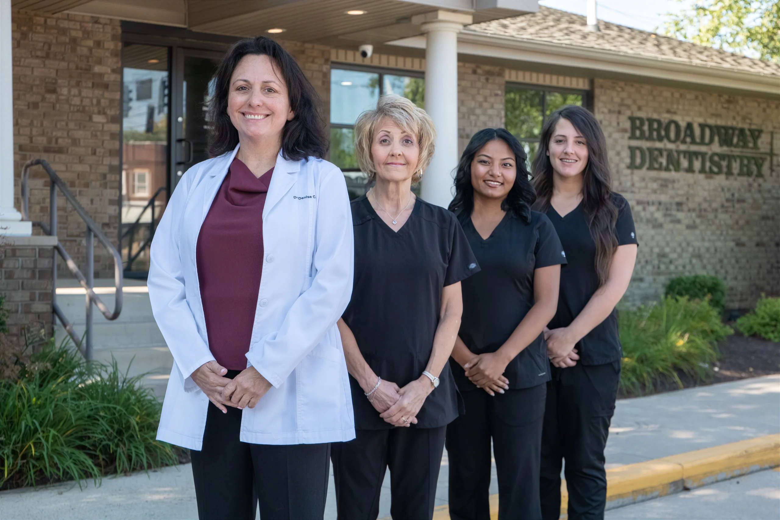 Dr. Denise Acosta with Becky, Zuzu and Kristin outside the Broadway Dentistry general dentistry office in Fort Wayne