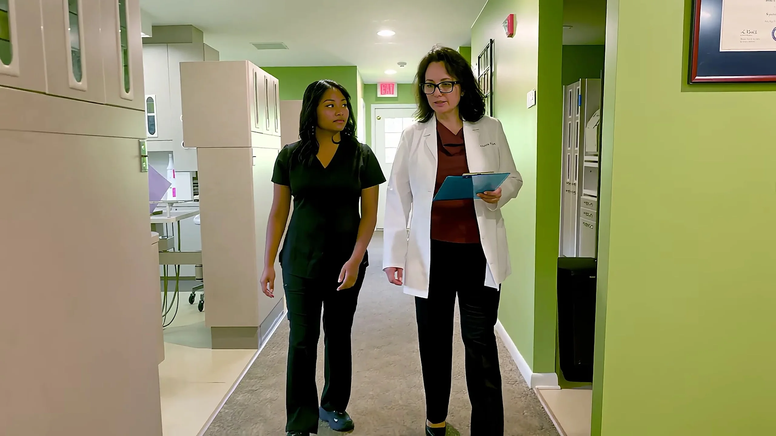 Dr. Acosta and a team member in the hallway at Broadway Dentistry in Fort Wayne, which offers TMJ bite guards and sleep apnea care